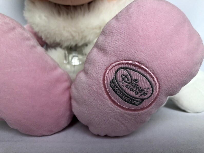 May include: Pink plush toy with a white fur collar and a Disney Store Exclusive tag on one foot.