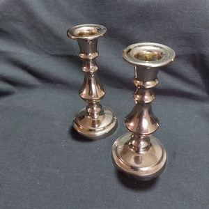 Pair of Mid-Century Chrome plated candlesticks made in England. Vintage chrome candle holders. Turned style candlesticks.