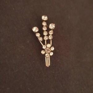Vintage Art Deco silver tone floral spray brooch set with faceted paste stones. Hand crafted