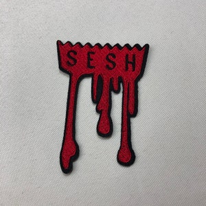 May include: Red embroidered iron-on patch with the word "SESH" in black lettering, dripping down like blood.