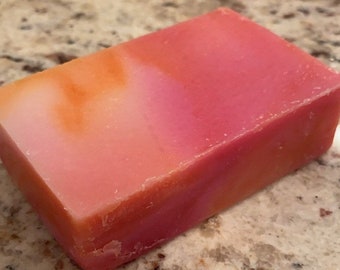 May include: A rectangular bar of soap with a pink and orange swirl pattern. The soap is made with natural ingredients and is perfect for sensitive skin.