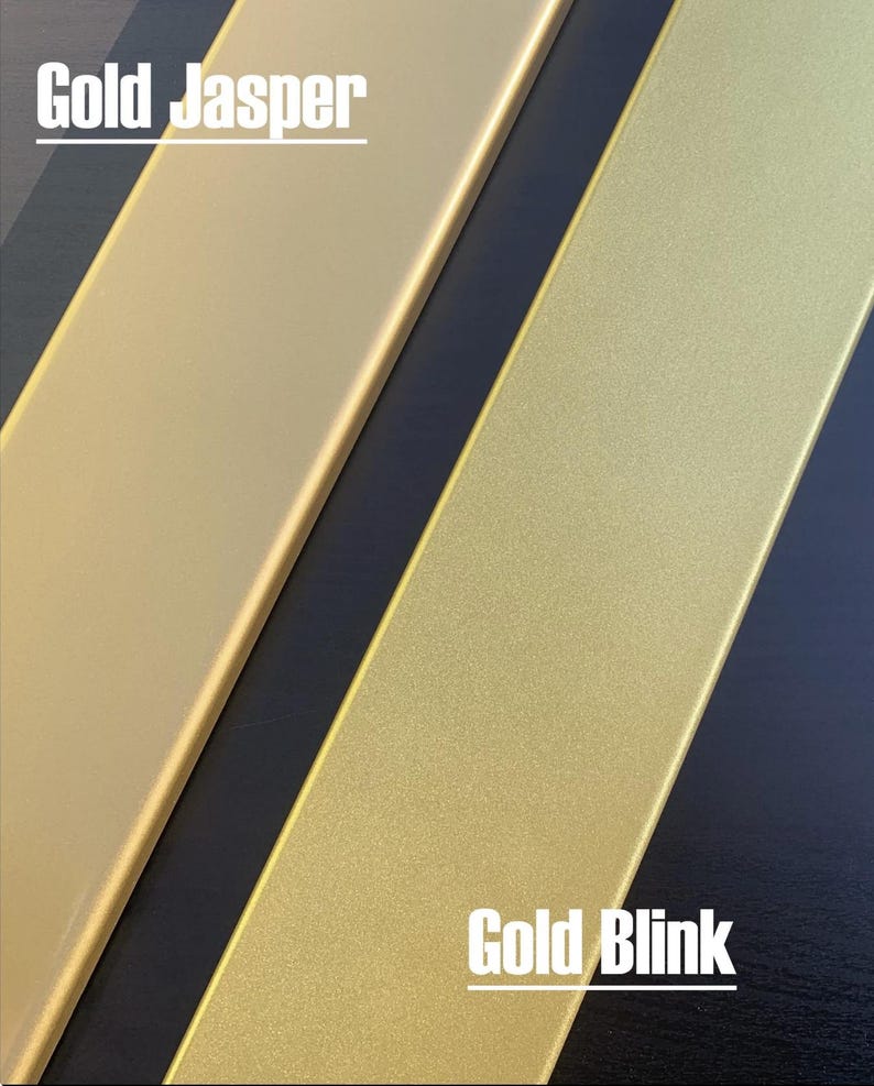 May include: Two gold-colored rectangular objects, labeled "Gold Jasper" and "Gold Blink", are displayed against a dark background. The "Gold Jasper" object has a smooth, matte finish, while the "Gold Blink" object has a textured, glittery appearance.