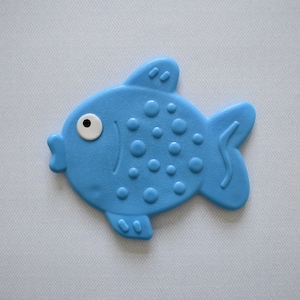May include: A blue plastic fish toy with a white eye and a textured surface. The fish has a curved tail and a small mouth.