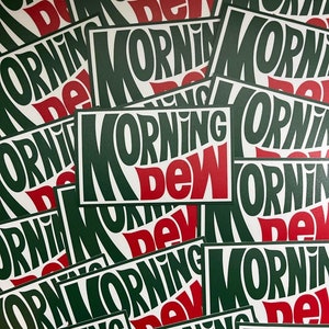 May include: A close-up of multiple stickers with the text "MORNING DEW" in a green and red color scheme. The stickers are stacked on top of each other, creating a layered effect.
