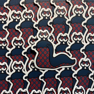 May include: A stack of blue and red snail stickers with white outlines. The snails are covered in a red and white donut pattern.