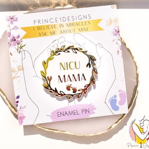 May include: Gold enamel pin with a wreath of leaves and the words "NICU MAMA" inside. The pin is on a white card with the text "PRINCE1DESIGNS I BELIEVE IN MIRACLES ASK ME ABOUT MINE ENAMEL PIN".