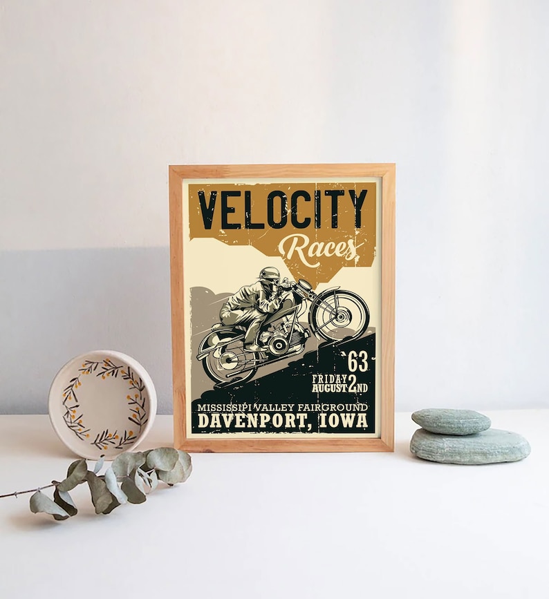 May include: A vintage-style poster advertising a motorcycle race called "Velocity Races". The poster features a black and white illustration of a motorcycle rider speeding up a hill. The text on the poster reads "Velocity Races", "Friday August 2nd", "Mississippi Valley Fairgrounds", and "Davenport, Iowa".