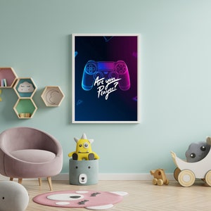 May include: A framed print with a neon blue and pink video game controller on a dark blue background. The text "Are you Player?" is written in white on the print.