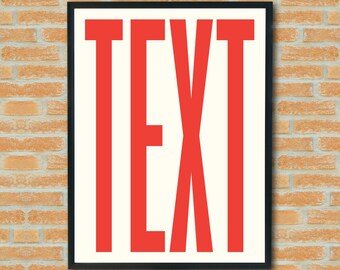 May include: A framed art print featuring the word "TEXT" in bold, red capital letters against an off-white background. The artwork is encased in a black frame and hangs on a brick wall.