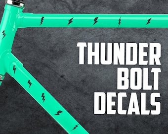 May include: A turquoise bicycle frame with black lightning bolt decals. The text "THUNDER BOLT DECALS" is printed in white on a gray background.