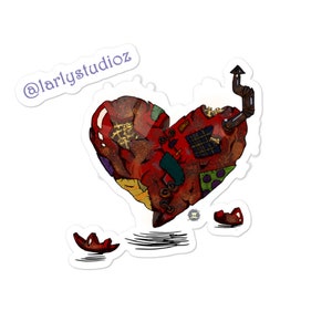 May include: A red, brown, and yellow heart-shaped object with a patchwork design and a small chimney on top. The heart is broken into three pieces, with two smaller pieces lying on the ground. The text "@larlystudioz" is visible in the upper left corner of the image.