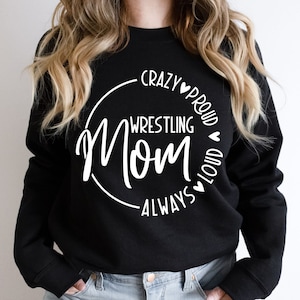 May include: Black sweatshirt with a white circle graphic that says "Crazy Proud Wrestling Mom Always Loud" with hearts.