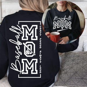 May include: Black sweatshirt with the words "Baseball MOM" in white script and block letters. The design includes a baseball and bat. The back of the sweatshirt has the word "Baseball" in script and the word "MOM" in block letters, with a baseball and bat graphic.