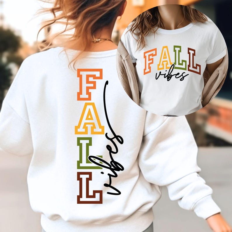 May include: White sweatshirt and t-shirt with the words "FALL vibes" in orange, yellow, green, and brown. The sweatshirt has the words vertically on the back. The t-shirt has the words horizontally on the front.