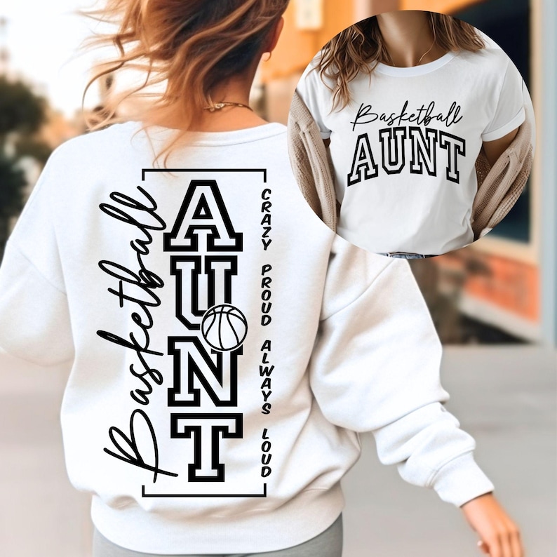 May include: White sweatshirt with the words "Basketball Aunt" and a basketball graphic. The back of the sweatshirt has the words "Basketball Aunt" vertically, with "Crazy, Proud, Always, Loud" printed on the side.