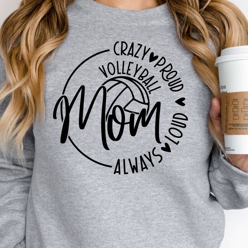 May include: Gray sweatshirt with a black graphic design that says "Crazy Volleyball Mom Always Proud Loud" with a volleyball graphic and hearts.