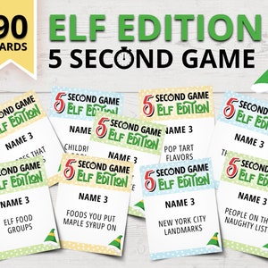 Peut inclure: Un jeu de 90 cartes pour un jeu de 5 secondes édition Elf. Les cartes sont vertes, jaunes, bleues et blanches avec des pois. Chaque carte porte le titre du jeu, "5 Second Game Elf Edition", et une invite pour les joueurs de nommer trois choses en cinq secondes. Les invites incluent "Groupes d'aliments des elfes", "Saveurs de tartes Pop" et "Personnes sur la liste des vilains".