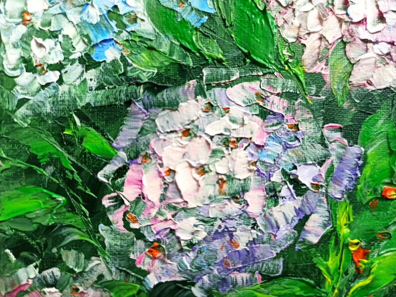May include: Close-up of a painting of purple, white, and pink flowers with green leaves. The flowers are painted with thick brushstrokes, giving the painting a textured look.