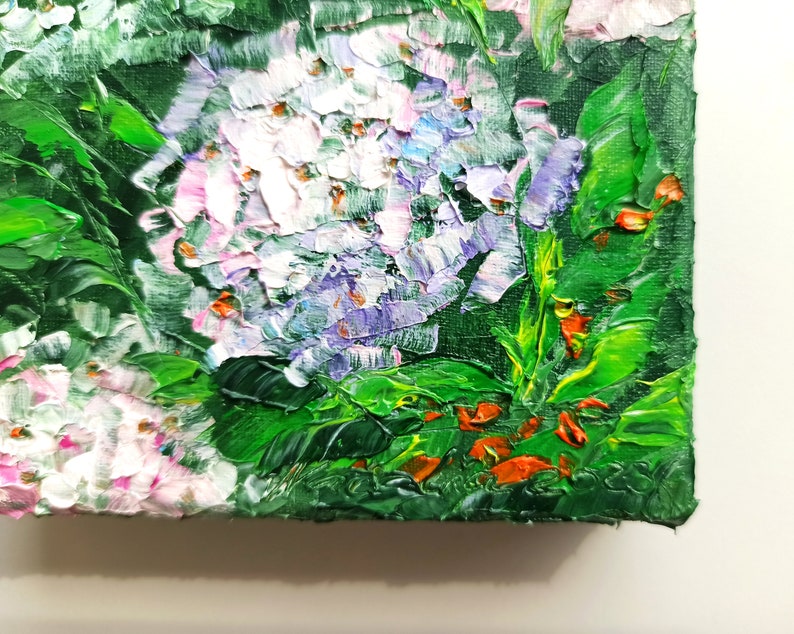May include: Close-up of an oil painting depicting a cluster of white and purple flowers with green leaves. The flowers are painted with thick, textured strokes, giving the painting a three-dimensional effect.