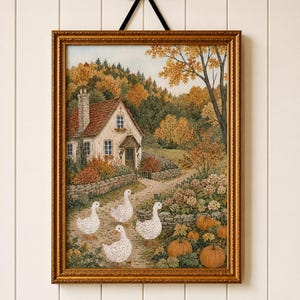 May include: A framed wall art print featuring a cottage with a red roof, surrounded by autumn trees and a stone wall. Four white ducks walk along a dirt path in the foreground, near a patch of orange pumpkins and green foliage in a gold frame.