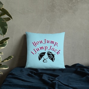 May include: A light blue throw pillow with the text "You Jump, I Jump Jack" in pink lettering and a black silhouette of two crossed umbrellas.