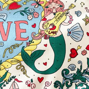 May include: A whimsical illustration featuring a mermaid playing a guitar with the word "HAPPY LOVE" on it. The design includes hearts, stars, musical notes, and nautical elements like a sailboat and rope, all set against a cream background.