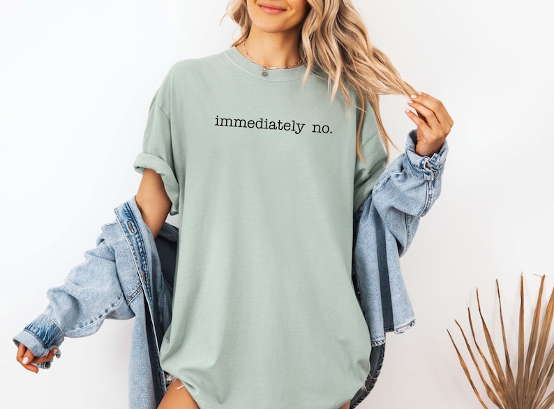 May include: A light green t-shirt with the text "immediately no." printed in black.