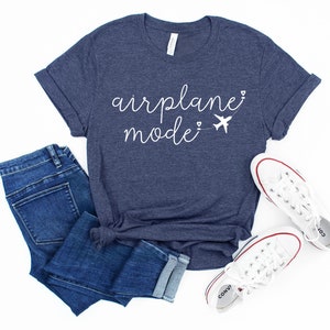 May include: A navy blue t-shirt with the text "airplane mode" in white script with a small airplane graphic and hearts.