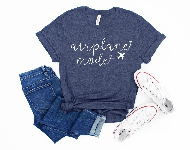 May include: A navy blue t-shirt with the text "airplane mode" in white script with a small airplane graphic and hearts.