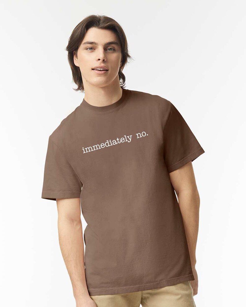 May include: A brown t-shirt with the text "immediately no." printed in white on the front.
