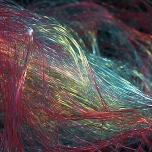May include: Abstract digital art featuring a swirling mass of colorful strands. The strands are primarily red, with accents of teal, yellow, and orange, creating a dynamic and textured visual effect against a dark background.