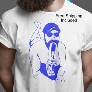 Gay art shirt of a Sexy Bearded man wearing a cap and biting a jockstrap. Hairy chested, Bearded in vivid colors. Original gay artwork
