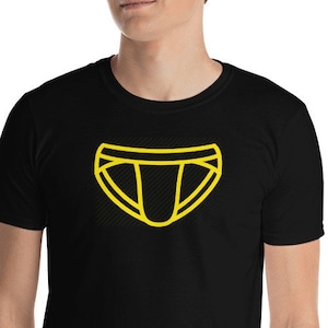 May include: A black t-shirt with a yellow outline of underwear on the front.