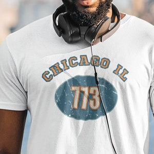 May include: White t-shirt with a blue and orange graphic that says "Chicago IL 773".