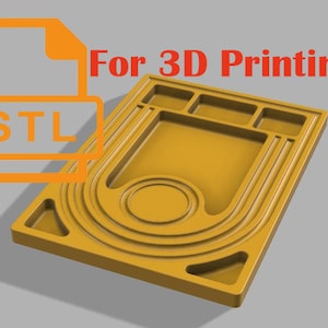 May include: A 3D printed, yellow, rectangular tray with multiple compartments and a circular indentation. The tray is designed for 3D printing and is available in STL format.