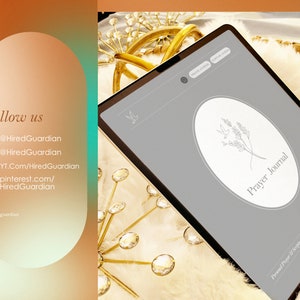 May include: A gray tablet with a white circle on the screen. The circle has a line drawing of a sprig of leaves and the text "Prayer Journal". The tablet is on a white fluffy surface with gold decorative items.