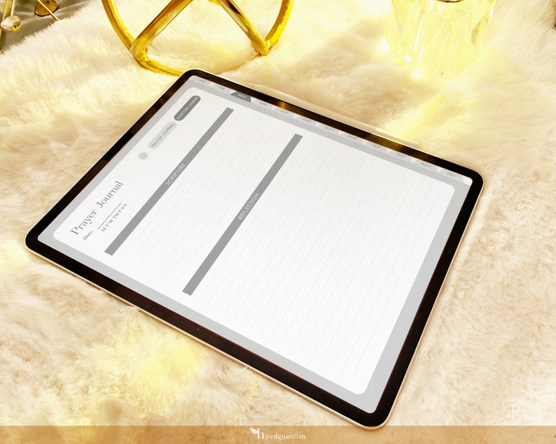 May include: A digital tablet displaying a printable prayer journal template with sections for date, scripture, prayer, and reflection. The template has a gray background and white lines.