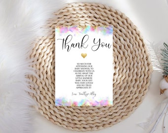 May include: Thank You card with a rainbow watercolor background and gold glitter accents. The text reads "Thank You" in a black cursive font with a gold heart. The text below reads "So much for attending our baby shower, to celebrate with us as we await the arrival of our little rainbow baby. Your gift was very lovely and we truly appreciate it! Love, Timothy & Alley"