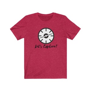 May include: Red short-sleeved t-shirt with a black and white compass graphic and the text "Let's Explore!"