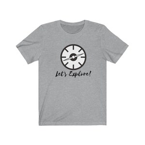 May include: A heather grey t-shirt with a black compass graphic and the text "Let's Explore!"