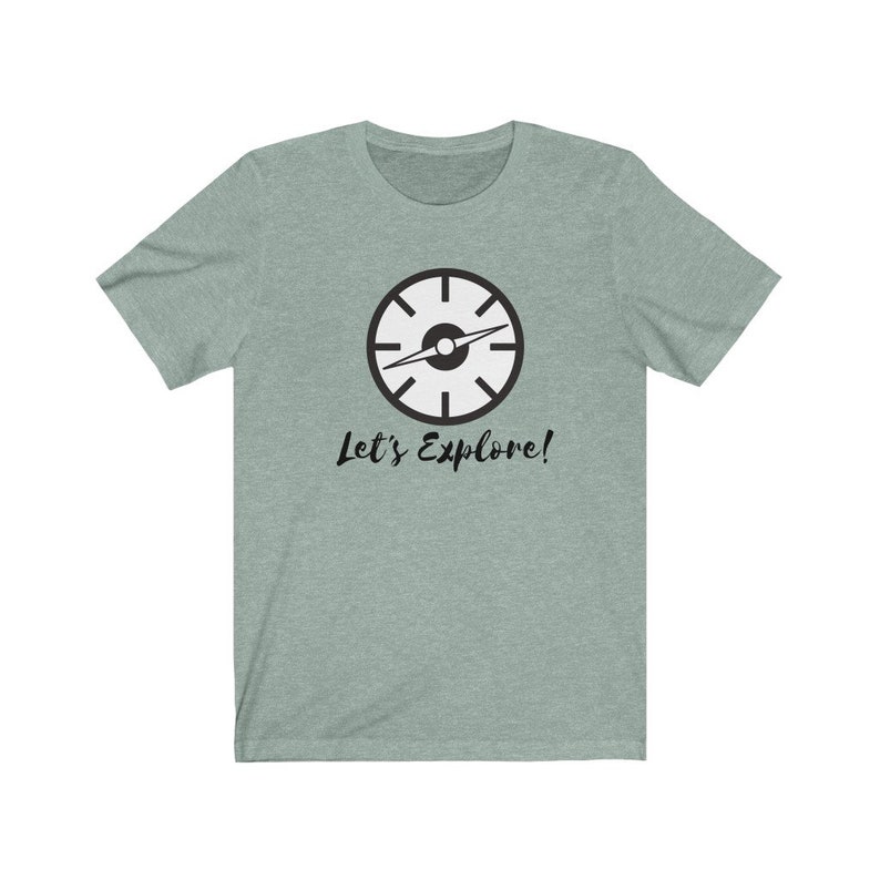 May include: A light green t-shirt with a black compass design and the text "Let's Explore!" printed on the front.