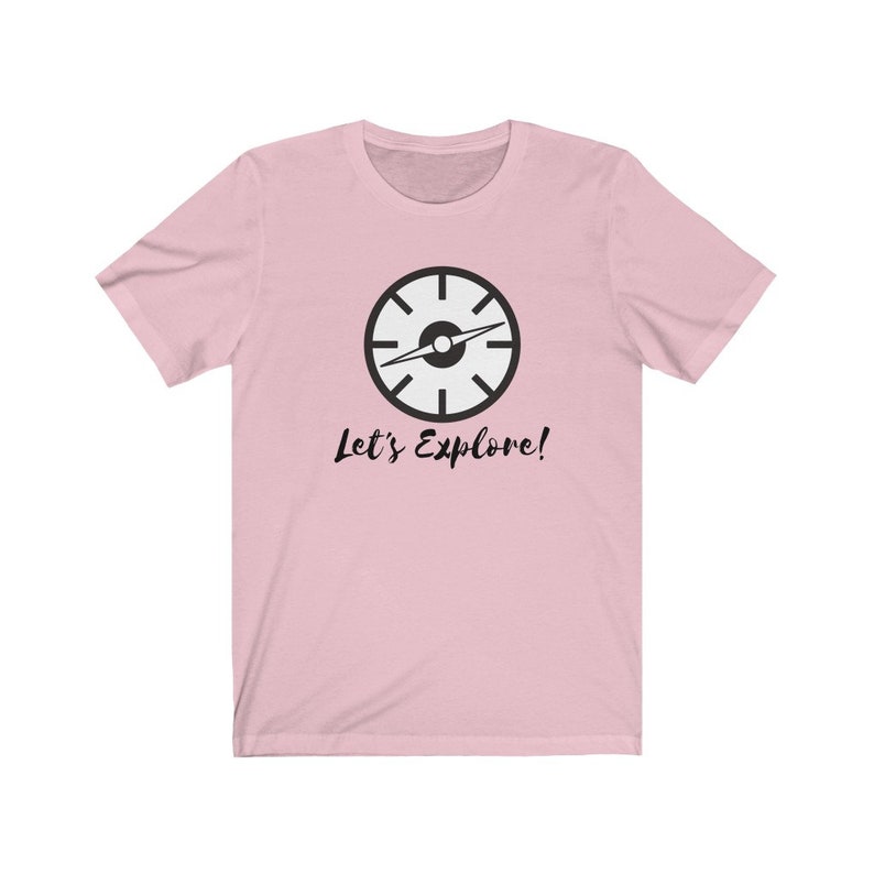 May include: Pink t-shirt with a black compass graphic and the text "Let's Explore!"