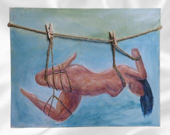 May include: An oil painting depicting a nude figure suspended by rope and clothespins against a blue and green background. The figure is painted in shades of pink and brown, with dark blue hair. The artwork is mounted on a canvas.