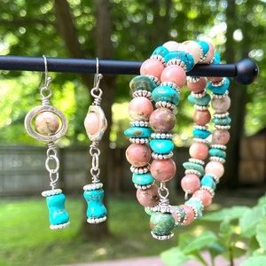 May include: A pair of silver earrings with pink and turquoise gemstone beads, and a matching bracelet with pink and turquoise gemstone beads.