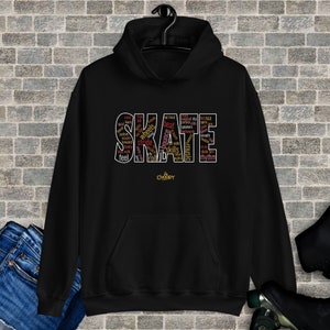 May include: Black hoodie with a word cloud design that spells out "SKATE" in large letters. The word cloud includes words related to skateboarding, such as "wheels", "bounce", "stride", "music", and "rhythm".