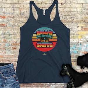 May include: A navy blue tank top with a retro-style graphic of a record with the text "Roll'n positive vibes Let's all Skate".