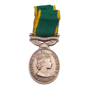 May include: A bronze medal with a green and yellow ribbon. The medal features a profile of a crowned person and the words "ELIZABETH II D:G: BR:OMN: REGINA F.D." The ribbon is green with yellow stripes.
