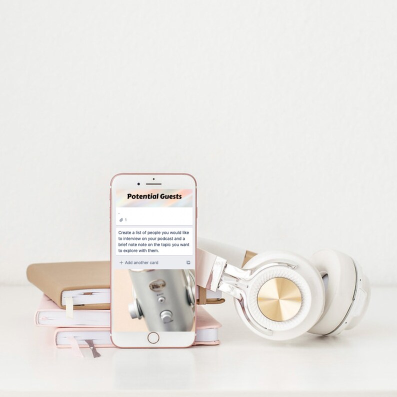 May include: A rose gold smartphone displays the text "Potential Guests" and a list of podcast interview ideas. White and gold headphones rest beside the phone, with a stack of notebooks in the background. The image suggests a podcasting or content creation theme.