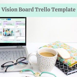 May include: A laptop computer open to a Trello board with three columns labeled "Relationship Goals", "Family Goals", and "Educational Goals". The laptop is on a white surface with a cup of coffee, glasses, and a notebook.