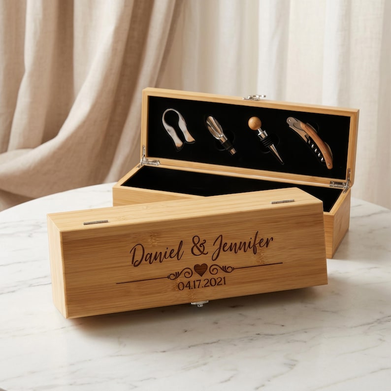May include: A wooden wine tool set in a bamboo box. The box is engraved with "Daniel & Jennifer" and the date 04.17.2021. The set includes a bottle opener, a foil cutter, a bottle stopper, and a corkscrew.